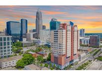 Beautiful high rise building with scenic skyline views and vibrant sunset at 222 S Caldwell St # 1812, Charlotte, NC 28202