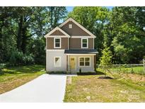 Charming two-story home with a modern exterior, neat lawn, and a newly poured concrete driveway at 2732 Mayfair Ave, Charlotte, NC 28208