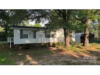 Charming home featuring white siding, gray shutters, and a welcoming front porch at 3264 Ledford Rd, Vale, NC 28168