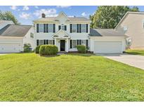 Charming two-story home with black shutters, tidy landscaping, and a well-manicured green lawn at 3702 Arthur St, Indian Trail, NC 28079