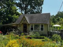 Charming home with a well-maintained yard and garden creates a beautiful curbside appeal at 4124 Oakwood Rd, Charlotte, NC 28269