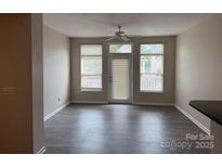Bright living room with hardwood floors, ceiling fan, and access to a balcony at 6112 Creft Cir, Indian Trail, NC 28079