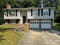 Charming two-story home with an attached two-car garage and a well-maintained lawn at 707 Regency Dr, Charlotte, NC 28211