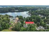Stunning aerial view of lakefront property at 8275 Normandy Rd surrounded by lush greenery and waterfront access at 8275 Normandy Rd, Denver, NC 28037