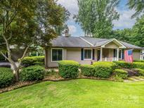 Charming home with manicured lawn, mature landscaping, and inviting entrance at 1047 Honeybee Trl, Fort Mill, SC 29715