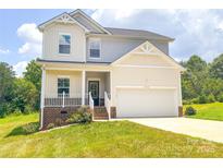Charming two-story home with a well-manicured lawn and attached two-car garage at 1542 Antioch Dr, Conover, NC 28613