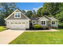 Charming single-Gathering home boasts a well-manicured lawn and an attached two-car garage at 1774 Timmons Marie Ln, Lincolnton, NC 28092