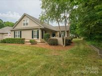 Charming single-Gathering home featuring a well-manicured lawn and lush landscaping at 2656 Polo Club Blvd, Matthews, NC 28105