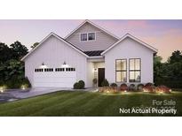 Charming new construction home featuring a spacious garage and black frame windows, set on a beautifully landscaped lawn at 4825 Reason Ct # 73, Harrisburg, NC 28075