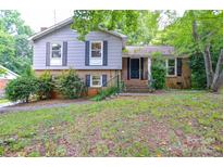 Charming two-story home featuring a brick and siding facade with well-maintained landscaping at 5008 Brooktree Dr, Charlotte, NC 28208