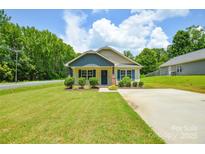Charming one-story home with beautiful lawn and well-manicured landscaping at 551 Sylvan Sw St, Concord, NC 28025