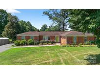 Charming single-story brick home with manicured lawn and mature trees in a desirable neighborhood at 622 S Carolina Ave, Statesville, NC 28677
