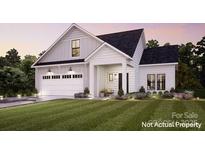 Charming new construction home with white siding, a manicured lawn, and an attached two-car garage at 7548 Baybrooke Ln # 26, Harrisburg, NC 28075