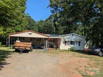 Charming single-Gathering home with a metal carport for parking and outdoor storage on a sunny day at 1110 Sulfur Springs Church Rd, Shelby, NC 28152