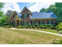 Beautiful brick home with lush landscaping and a welcoming walkway, showing its charming curb appeal at 1503 Jack White Dr, Rock Hill, SC 29732