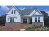 Beautiful new construction home with brick base, white siding, and covered front porch at 156 Triple Ponds Ct, Clover, SC 29710