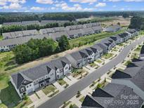 Beautiful aerial view of a well-planned community featuring modern townhomes and lush landscaping at 228 Briana Marie Way, Indian Trail, NC 28079