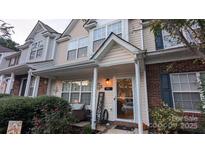 Charming townhome featuring a cozy front porch and well-maintained landscaping at 311 Wilkes Place Dr, Fort Mill, SC 29715