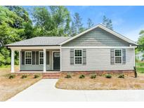 Charming single-story home featuring horizontal siding, complementary color accents, and a well-maintained landscape at 671 Sylvan Sw St, Concord, NC 28025