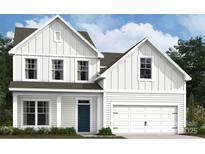 Charming two-story home with a white exterior, black door and a two car garage at 1488 Kate Cecil Way, York, SC 29745