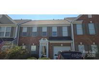 Charming brick townhome featuring a one-car garage and well-maintained landscaping at 162 Autumn Falls Dr, Lake Wylie, SC 29710