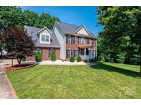 Charming two-story brick home with black shutters and a well-manicured lawn at 2635 Mahogany Ln, Hickory, NC 28602
