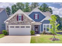 Charming home featuring stone accents, a two-car garage, and manicured lawn at 3018 Trace Meadow Ct # 125, York, SC 29745