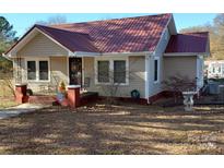 Charming single-story home with a cozy porch and beautiful red metal roof at 4303 Grier St, Gastonia, NC 28056
