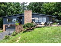 Beautiful one-story home with a brick chimney and a deck overlooking the lush greenery at 109 Joe Teague Rd, Hickory, NC 28601