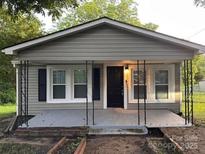 Charming single-story home with neutral siding and a covered front porch at 1849 Hilltop Cir, Gastonia, NC 28054