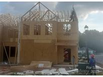 Two-story home under construction showing wall framework and roof trusses at 2903 Herringbone Rd # 35, Charlotte, NC 28208