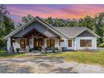 Charming exterior of a home with stone accents, wooden beams, and a covered porch at 4033 Hilton Lake Rd, Kannapolis, NC 28083