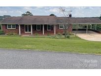 Charming brick ranch home with a cozy front porch, carport, and a well-maintained front yard at 114 Joe Teague Rd, Hickory, NC 28601