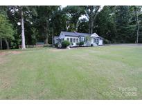 Charming white home featuring a well-maintained front yard and mature trees at 1257 Reese Roach Rd, Rock Hill, SC 29730