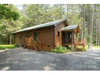 Charming log cabin home with a covered porch nestled among the trees at 164 Pleasant Creek Dr, Cleveland, NC 27013
