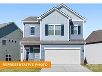 Charming two-story home featuring a two-car garage and light blue siding with navy shutters at 2202 Catawba Trace Dr, Catawba, NC 28609