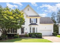 Charming two-story home with white siding, black shutters, and a well-manicured front yard with mature trees at 10230 Blackstock Rd, Huntersville, NC 28078