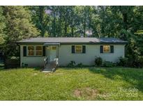 Charming single-story home with brick facade, black shutters and an inviting front yard at 1048 Shenandoah Dr, Gastonia, NC 28052