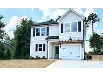 Two story home featuring a white exterior, black shutters, a covered front porch, and an attached garage at 1683 Interstate View Dr, Gastonia, NC 28052