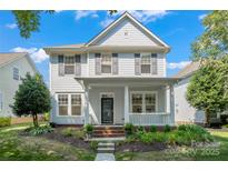 Charming two-story home with a welcoming front porch and beautifully landscaped yard at 17514 Harbor Walk Dr, Cornelius, NC 28031