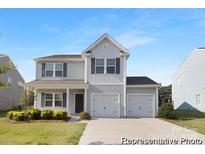 Charming two-story home featuring a two-car garage and manicured landscaping at 6032 Santee River Way # 50, Belmont, NC 28012