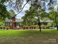 Charming brick home featuring a well-maintained lawn and mature landscaping at 506 Hearne Farm Rd, Mount Gilead, NC 27306