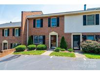 Brick townhouse with black shutters, manicured bushes, and parking at 709 21St Ne Ave, Hickory, NC 28601