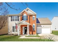 Charming two-story home with a brick facade, well-manicured lawn and American flag at 8351 Rolling Meadows Ln, Huntersville, NC 28078