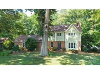 Charming two-story home with a well-manicured lawn and mature trees at 12101 Ranburne Rd, Mint Hill, NC 28227