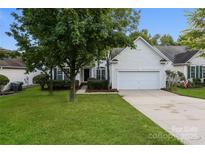 Charming home featuring a well-manicured lawn, mature trees, and a bright white exterior at 3422 Balsam Tree Dr, Charlotte, NC 28269