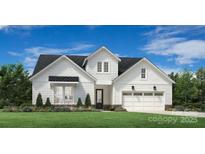 Charming, new construction two-story home with white siding, dark roof, and meticulously manicured lawn at 4161 Eastover Glen Rd # 0338, Charlotte, NC 28269