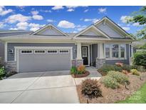 Charming single-story home with a two-car garage and well-maintained landscaping with colorful plants at 537 Lincoln Quarters Ln, Fort Mill, SC 29708