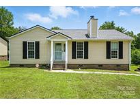Charming single-story home with a well-manicured lawn and black shutters at 8106 Strawberry Point Dr, Charlotte, NC 28215