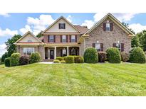Beautiful two-story brick home featuring a well-manicured lawn, shutters, and a welcoming front porch at 3113 Beaver Dam Dr # 37, Monroe, NC 28110